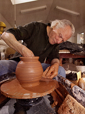 Maynard Tischler sitting at a pottery wheel