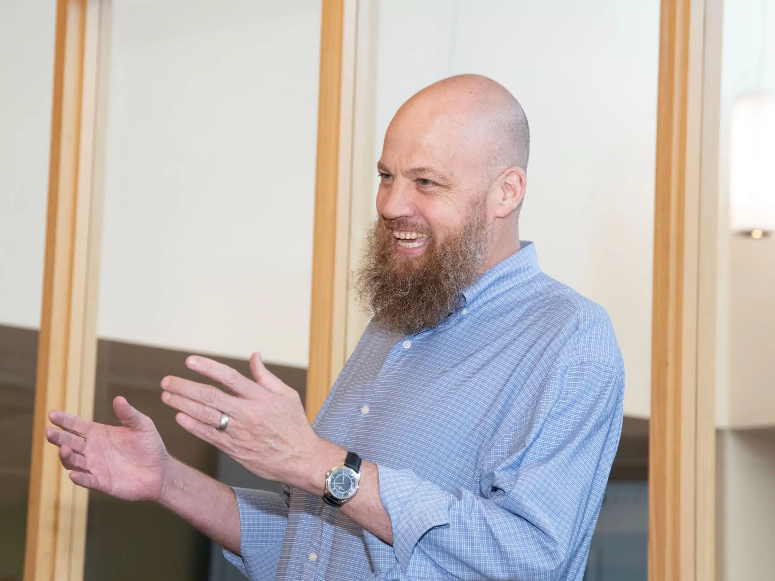 A man laughs while talking.