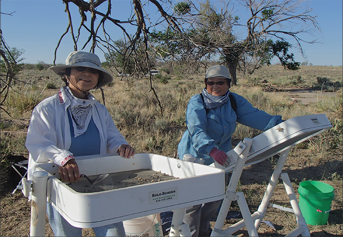 Volunteers, both at Amache as young girls, screen soil from excavations. Courtesy of the DU Amache Project.
