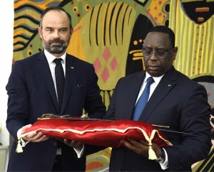 French prime minister Edouard Philippe hands the sword of Omar Saidou Tall to Senegal president Macky Sall.