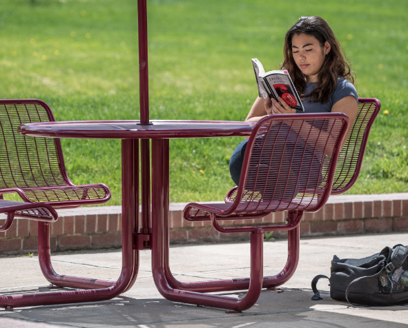 Student on campus reading a book