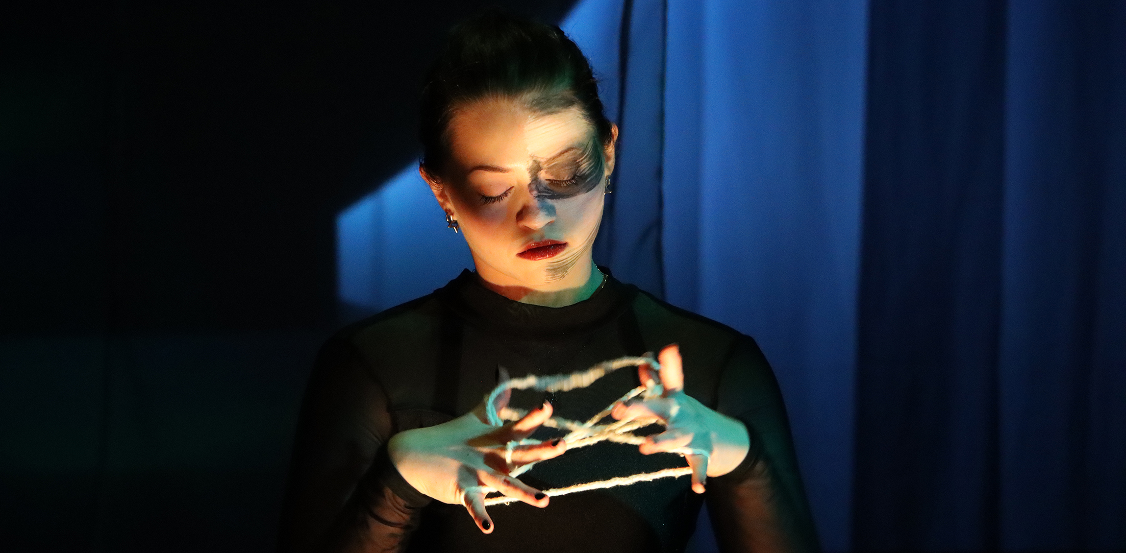 A DU Theatre Student acting on stage.