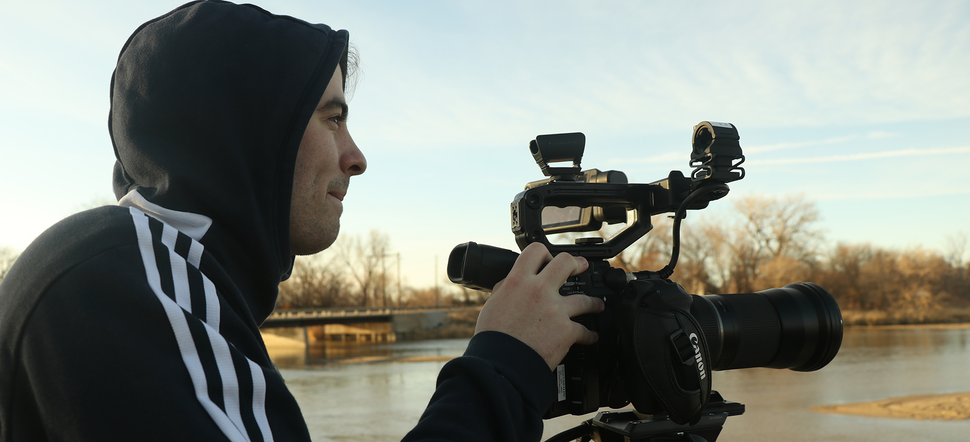 A DU alumni shooting a short film on a video camera.