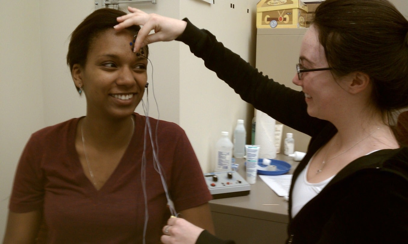 Two people using science equipment. 