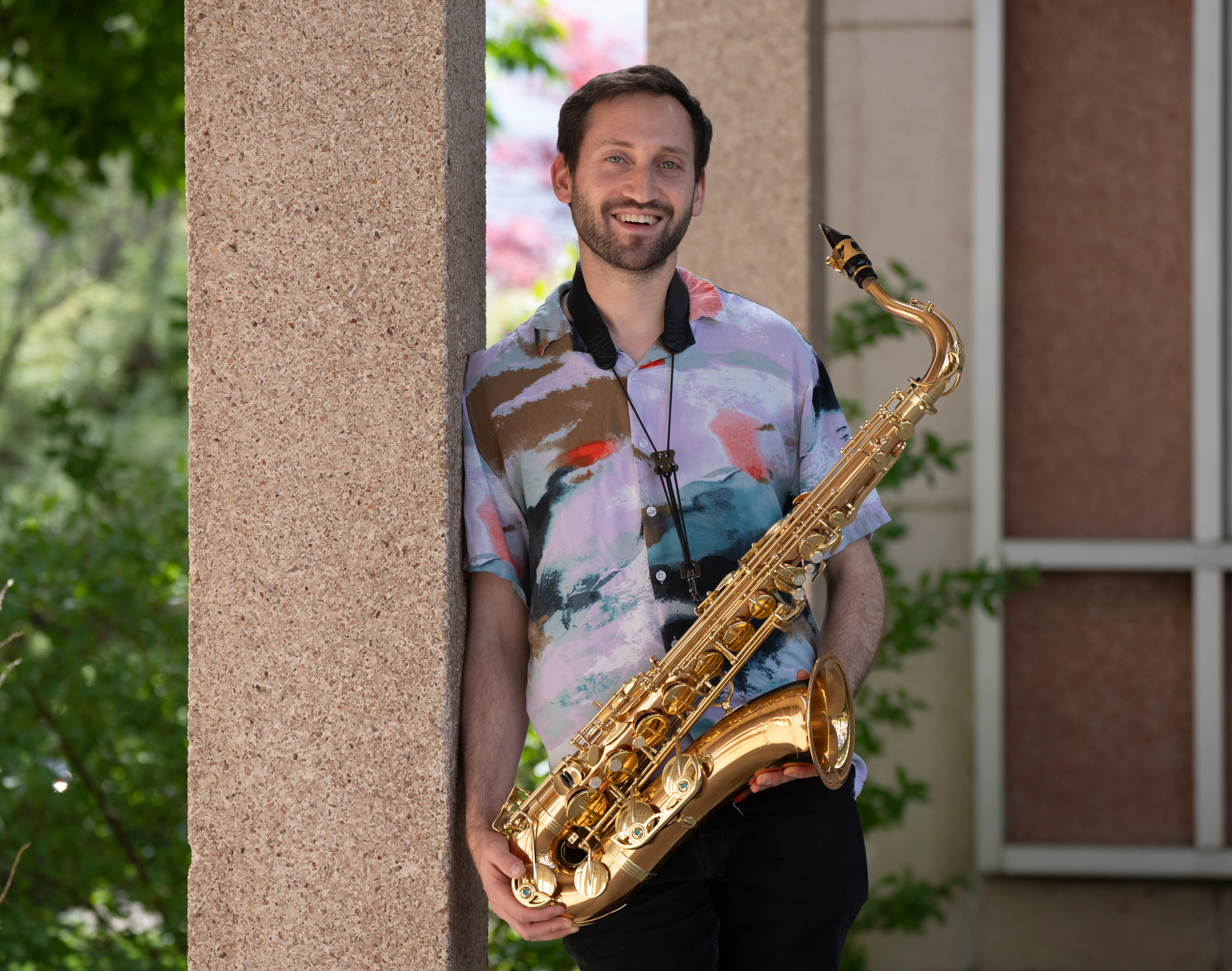 Portrait of Adam Gang and his saxophone.
