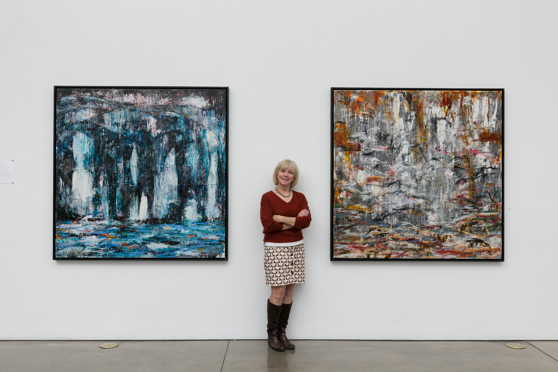 Woman standing in front of art work