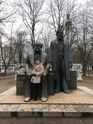 Photo of Rachel Thomas with statues of philosophers Marx and Engels 
