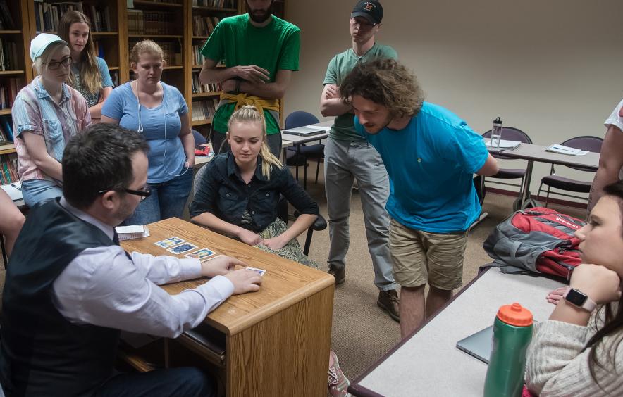 students talking in class and gathered around