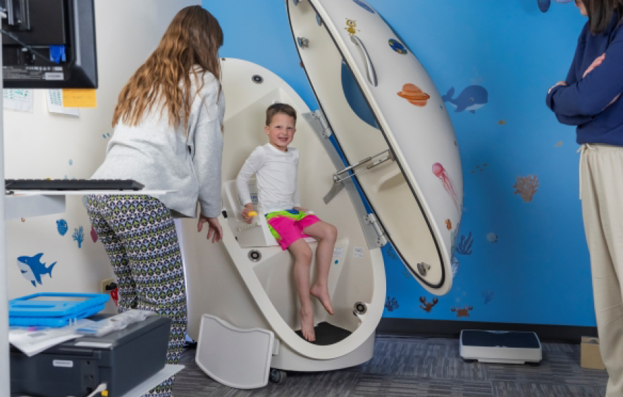kid sitting in a bodpod
