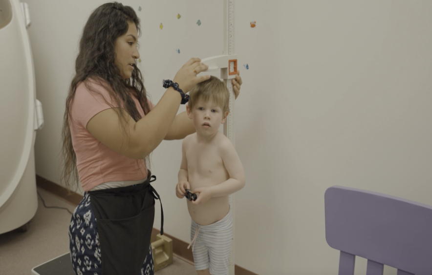 Research Assistant Measuring a Participant's Height