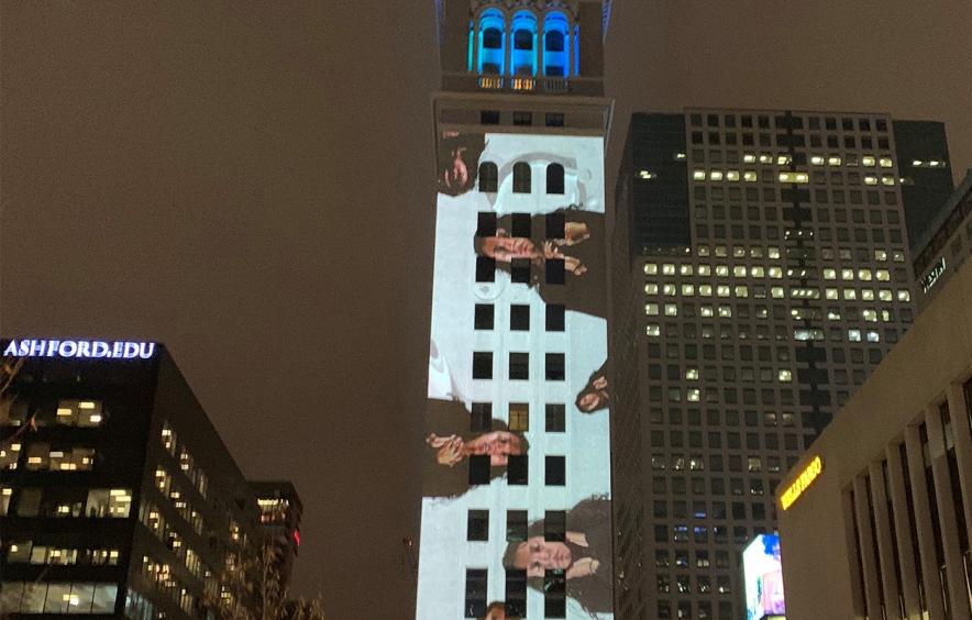 Faces projected on the Denver clock tower as part of DU EDP professor Laleh Mehran's class