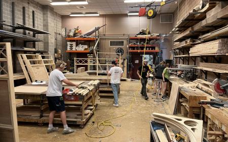 Students building a set in a workshop.