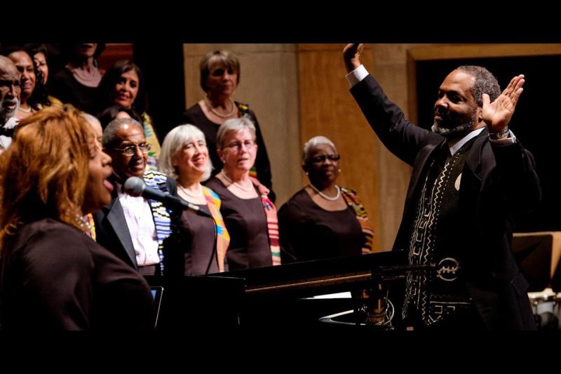 Roger Holland standing in front of choir