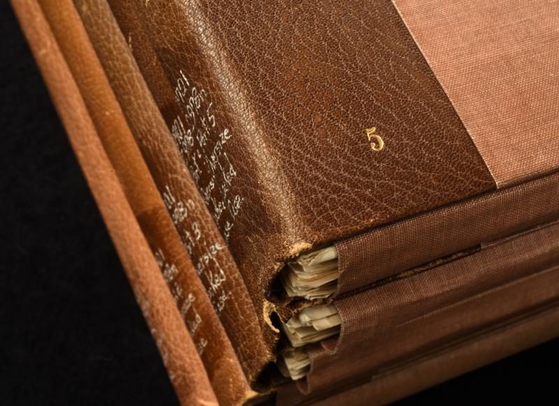 the spines and partial front covers of four leather-bound texts