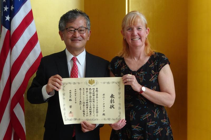 Bonnie Clark receives a commendation from the Denver's Consul General to Japan Mikami Yoichi.