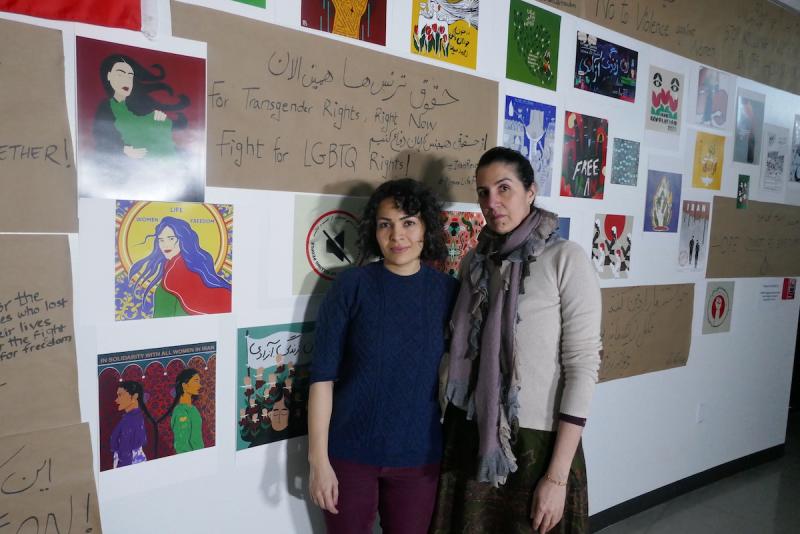 DU Professor Poupeh Missaghi and Ph.D. candidate Mona Moayedi stand in front of exhibit