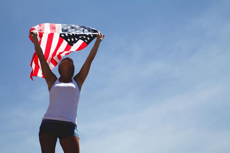 Photo of woman holding an American flag