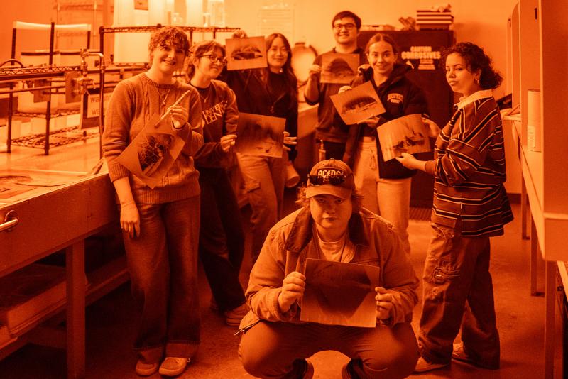 Students print photos in dark room