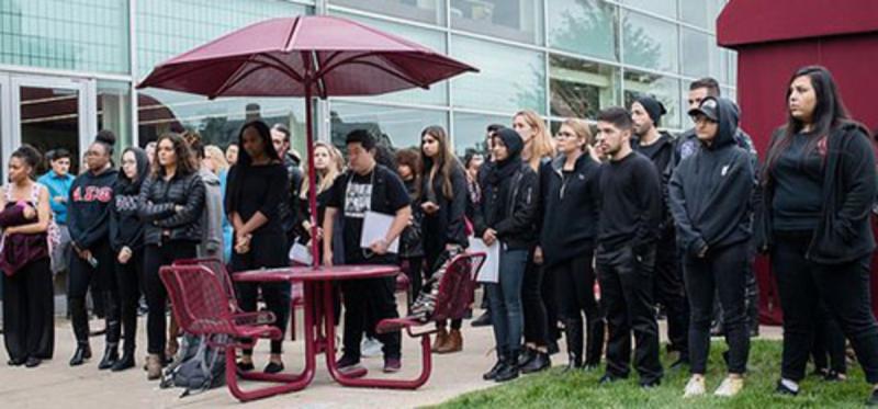 Students gather at the Free Speech wall in October 2017 for a "Take a Knee" event hosted by the Social Justice Advocacy group on campus