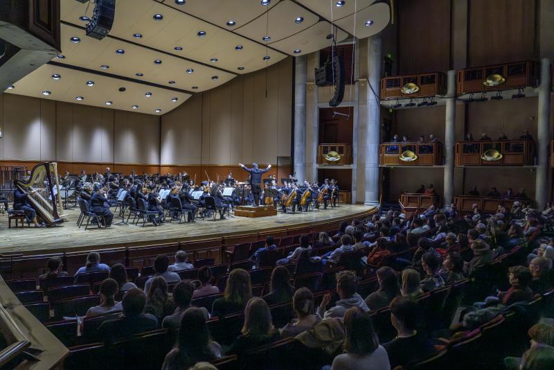 Audience and stage of a Lamont winter concert in Gates Hall.