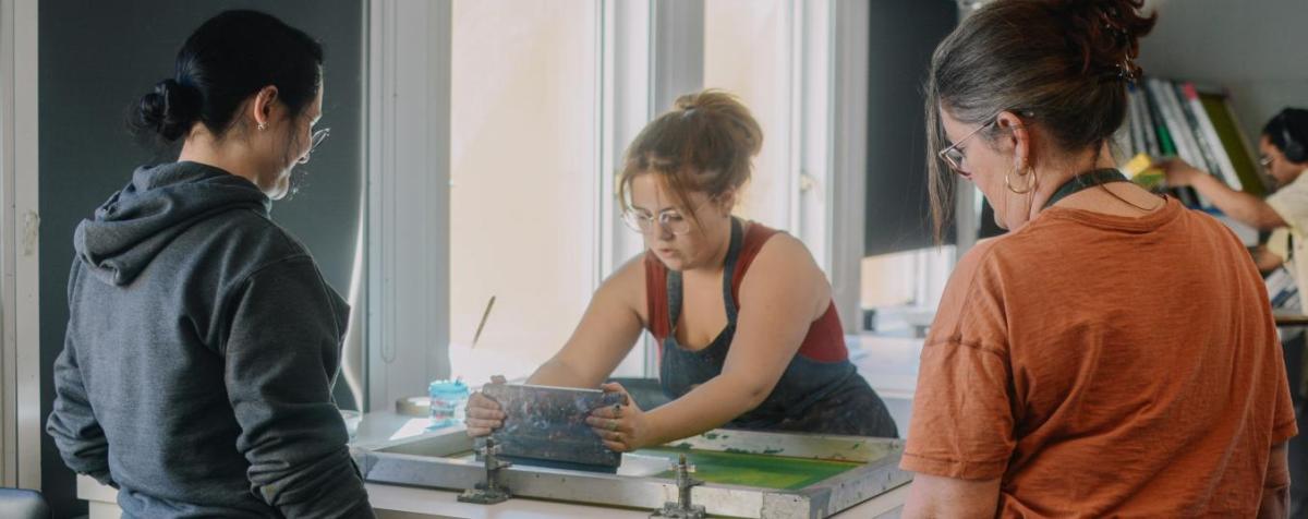 Student applies pigment to a print form