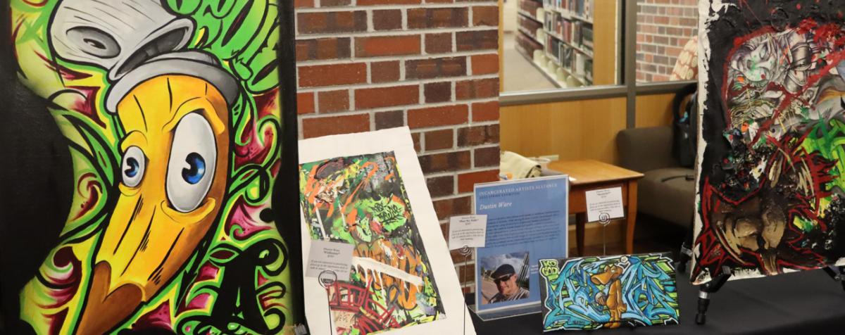 Abstract art created by a currently incarcerated artist on display at an event.