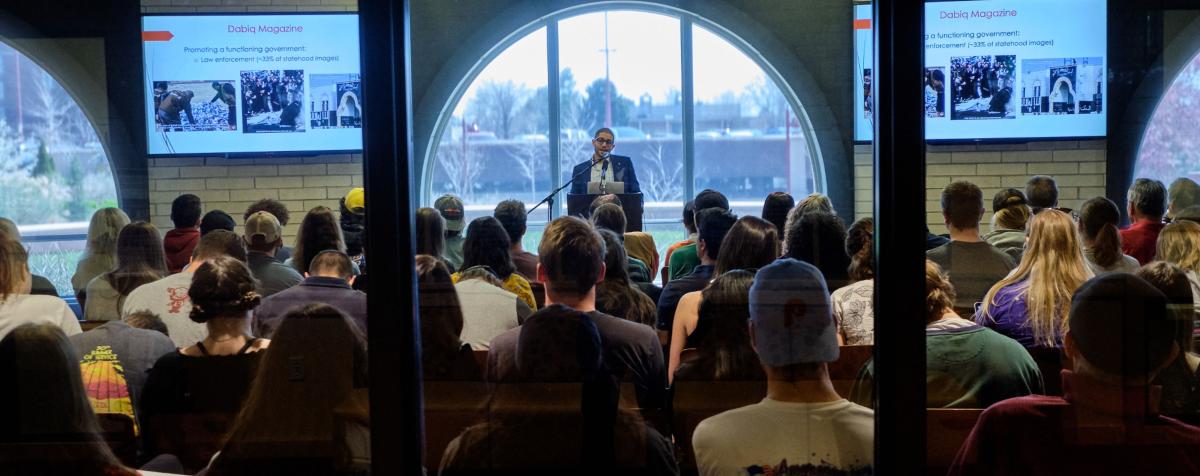 a lecturer presents to a full classroom
