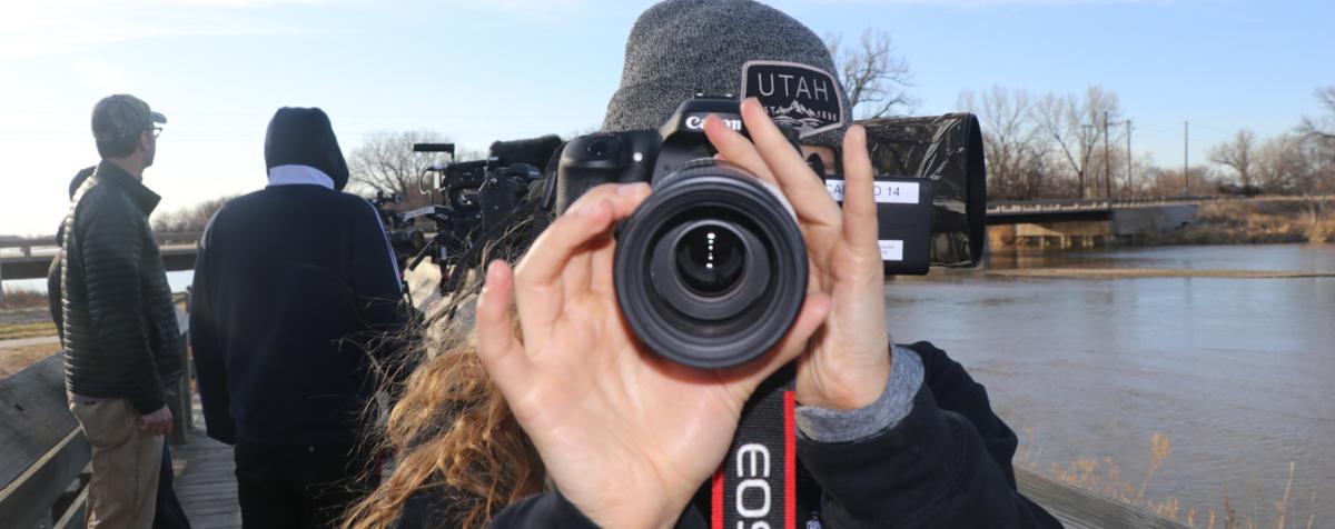 student holding camera