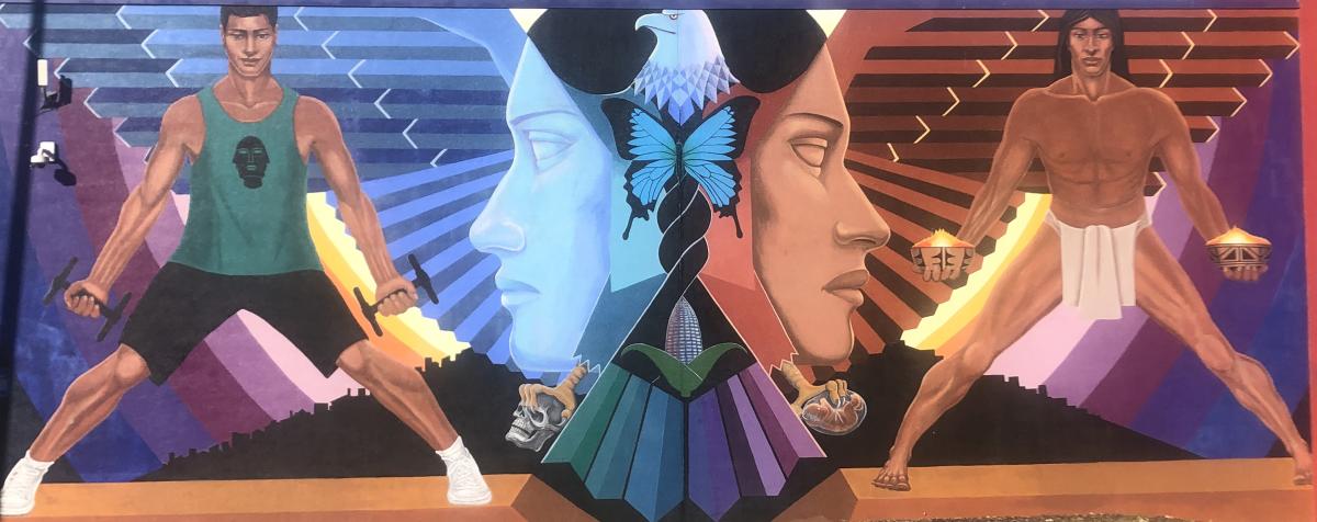 A photo La Alma, a mural by Emanuel Martinez, depicting an Eagle above two women's faces, and two men, one a contemparary man and the other an ancient indigenous figure.  