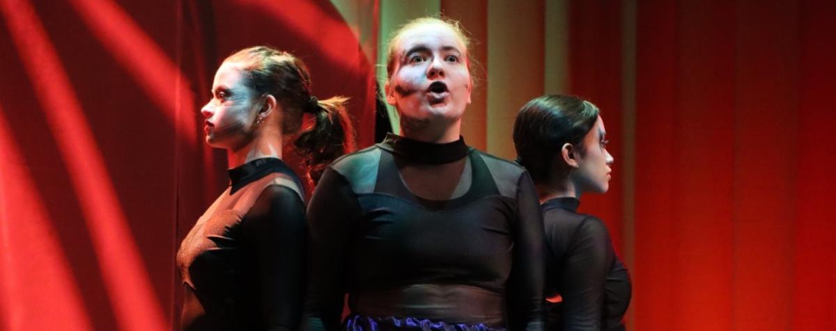 students performing on stage