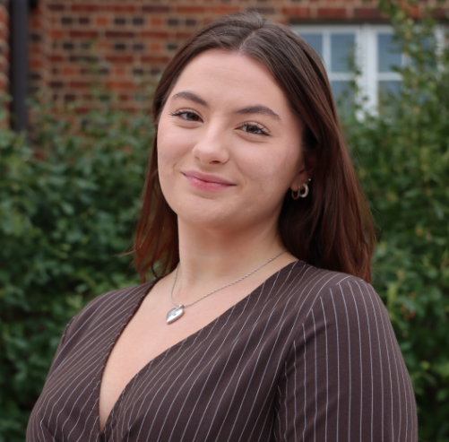 A woman smiles at the camera.