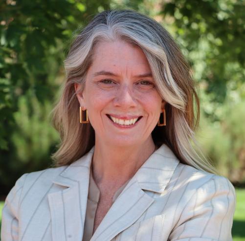 A woman smiles at the camera.