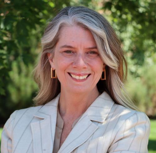 A woman smiles at the camera.