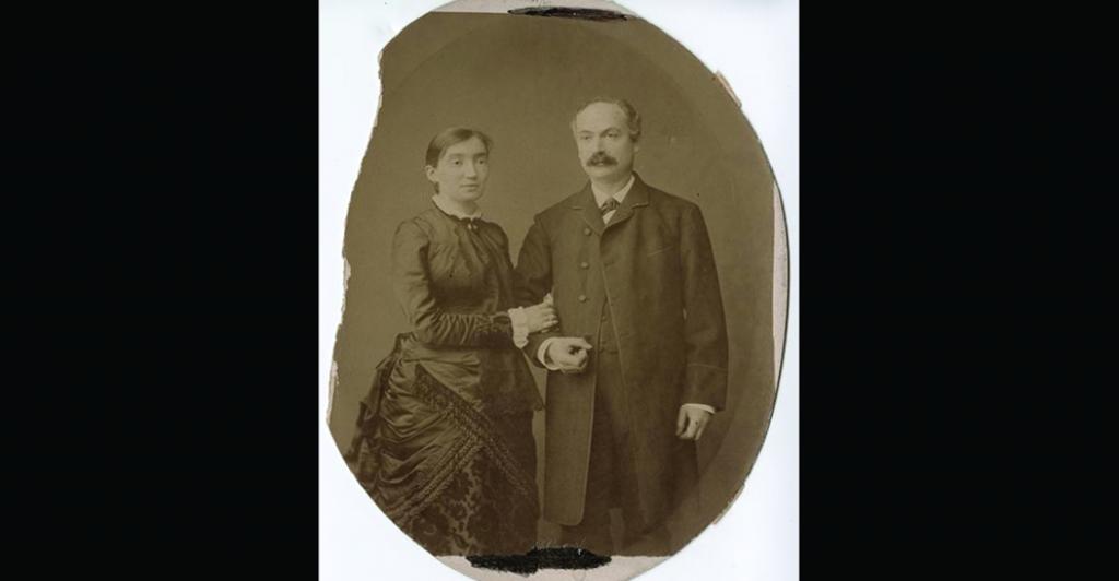A sepia-tone photograph of two people dressed in black, early 1900s clothing,Ernestine and Emil Loewenstein, circa 1906