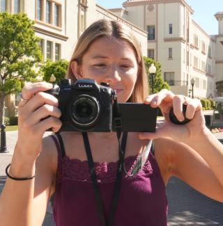 Student holding camera