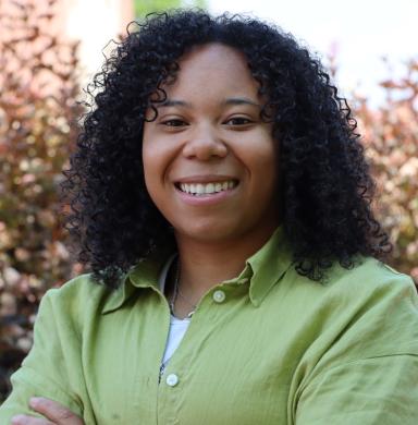 A woman smiles at the camera.