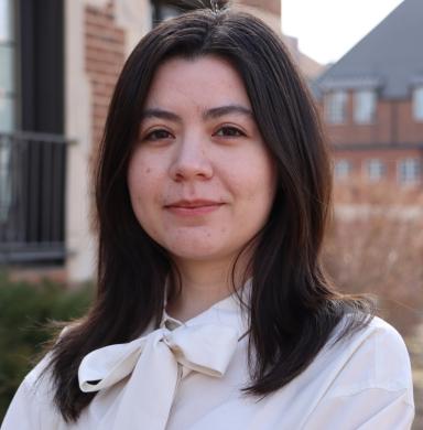 A woman smiles at the camera.