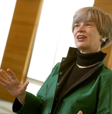 A woman speaks to a group of people.