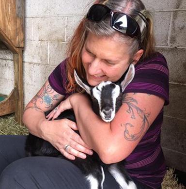 Sarah Gjertson and baby goat at Broken Shovels Farm Sanctuary 