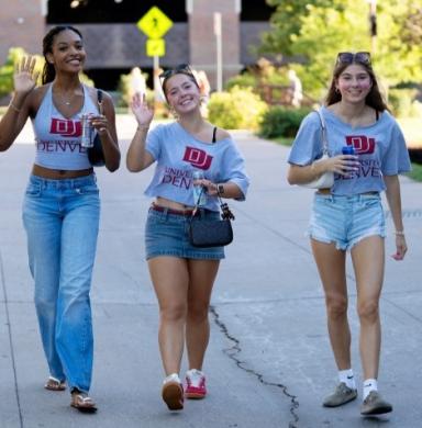 students smiling and waving 