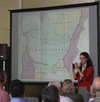 Photo of Susan Schulten presenting in front of a map