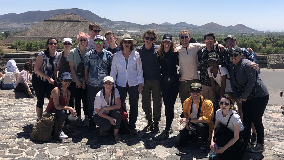 group photo outdoors with mountain range in background