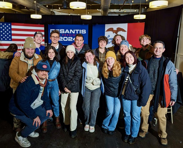 Seth Masket and a group of DU students pose for a group photo during a campaign event at the 2024 Iowa caucuses.