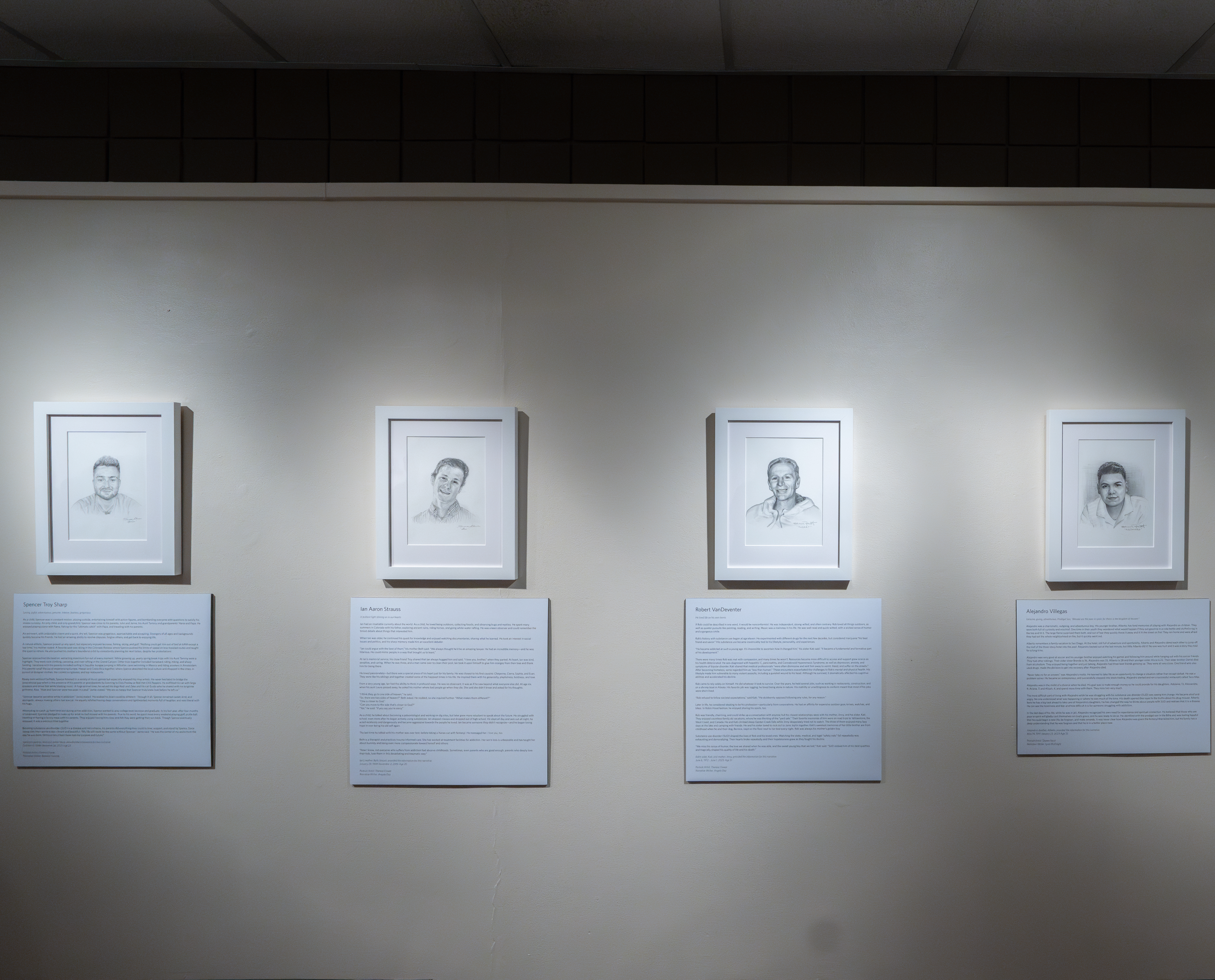 A gallery of drawings of people at the Into Light exhibit at the University of Denver.